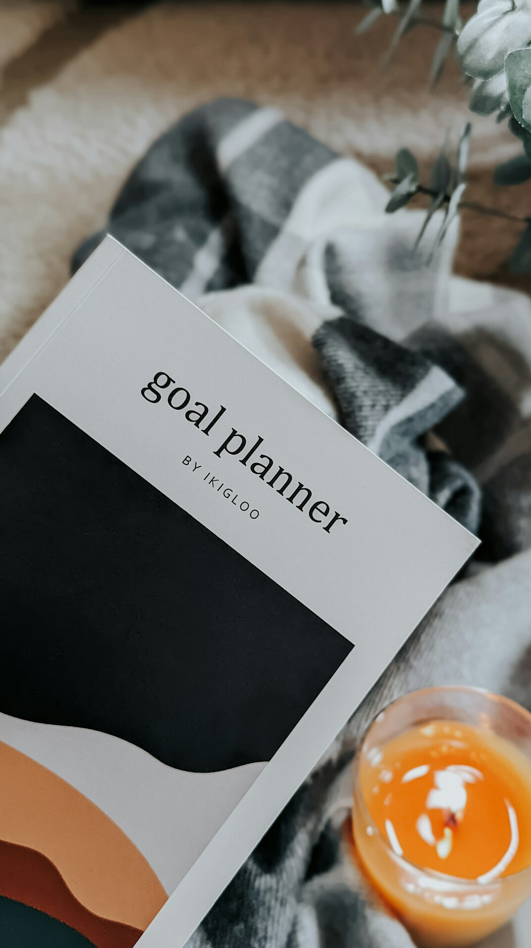 Wall calendar and notebook with long-term goals on a desk by a window