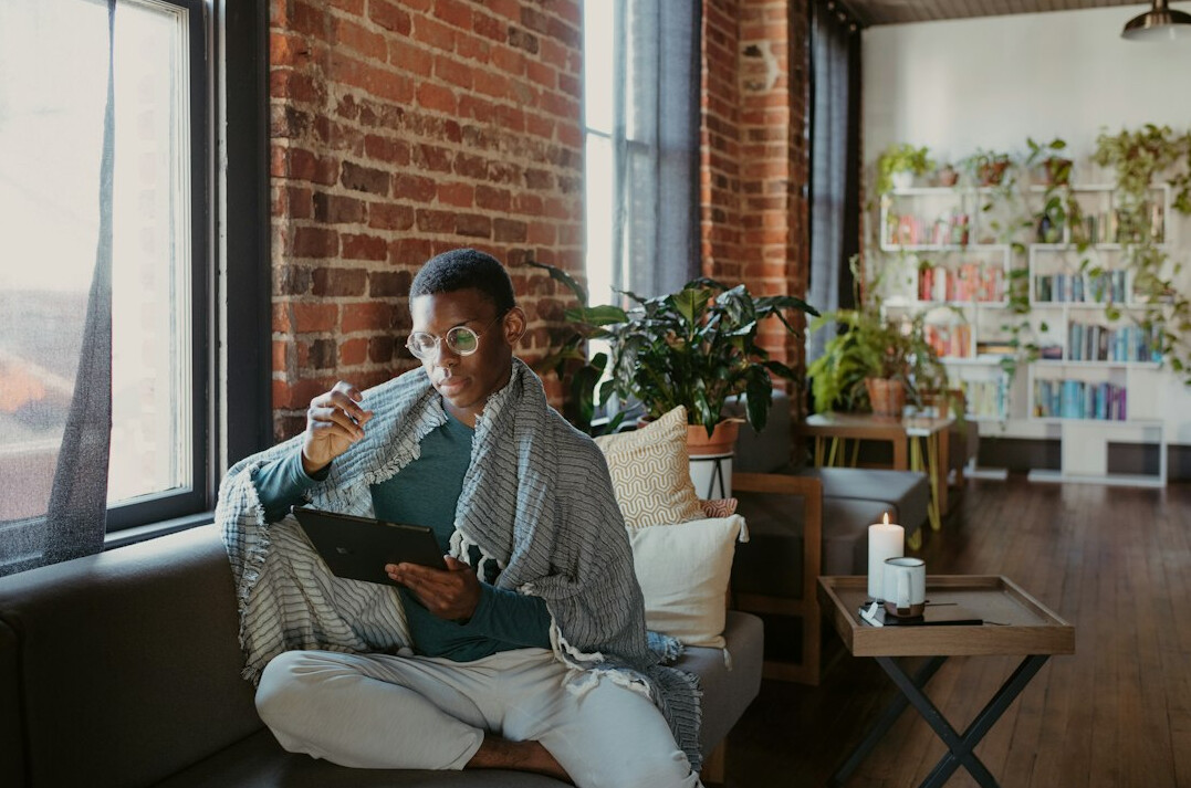person reading finance book at home