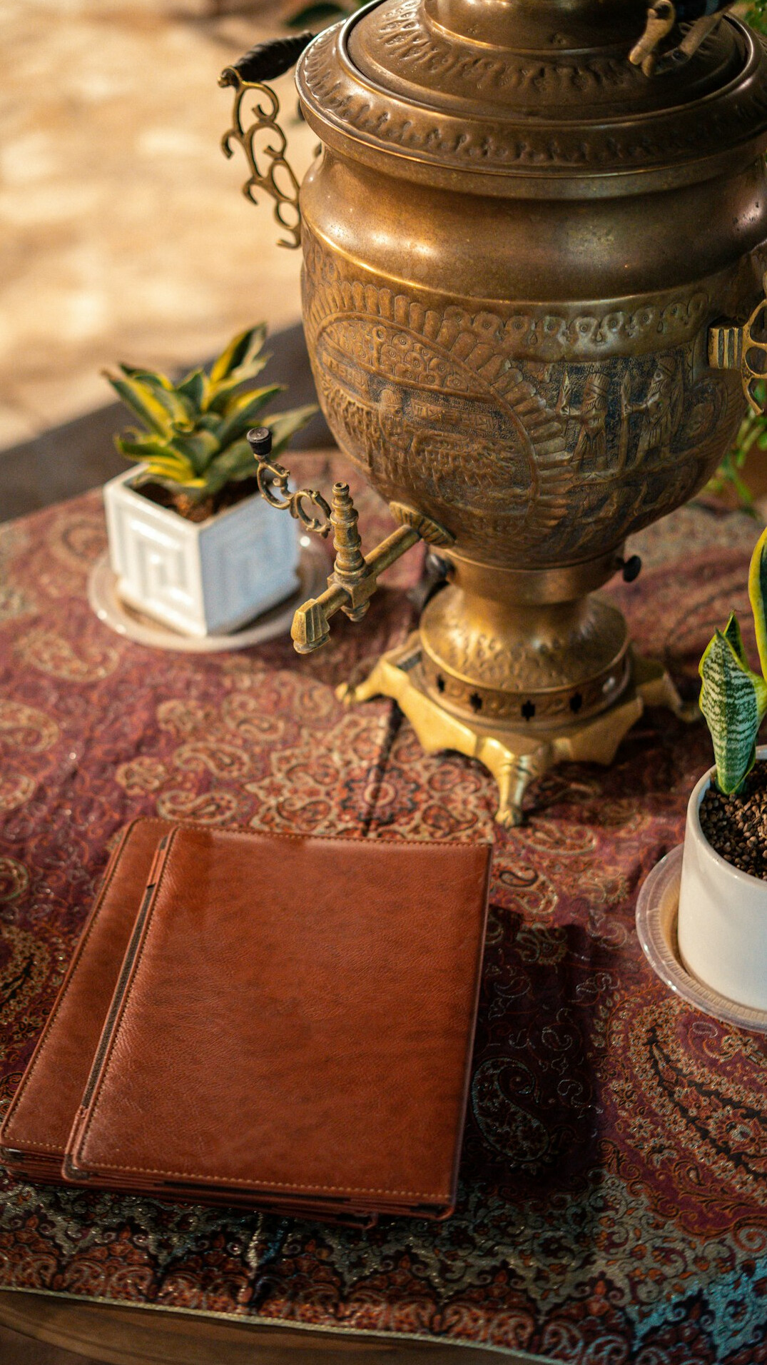 Cup of mate and notebook on a table by a window
