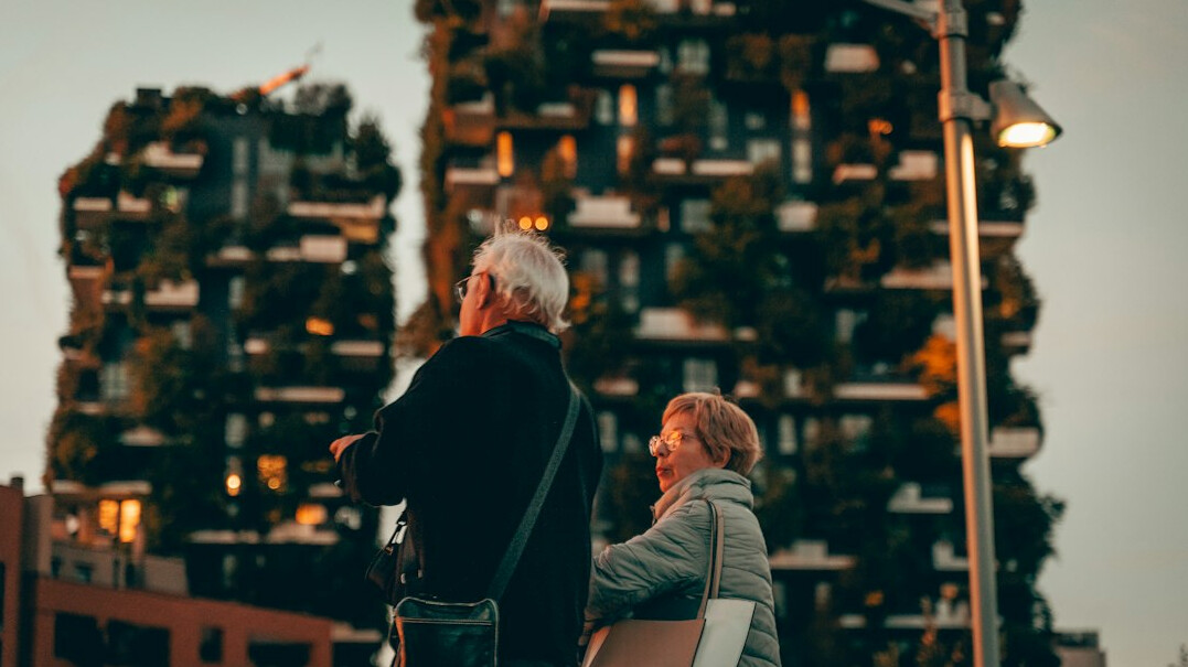 Mature Latin American couple discussing household expenses at a dining table