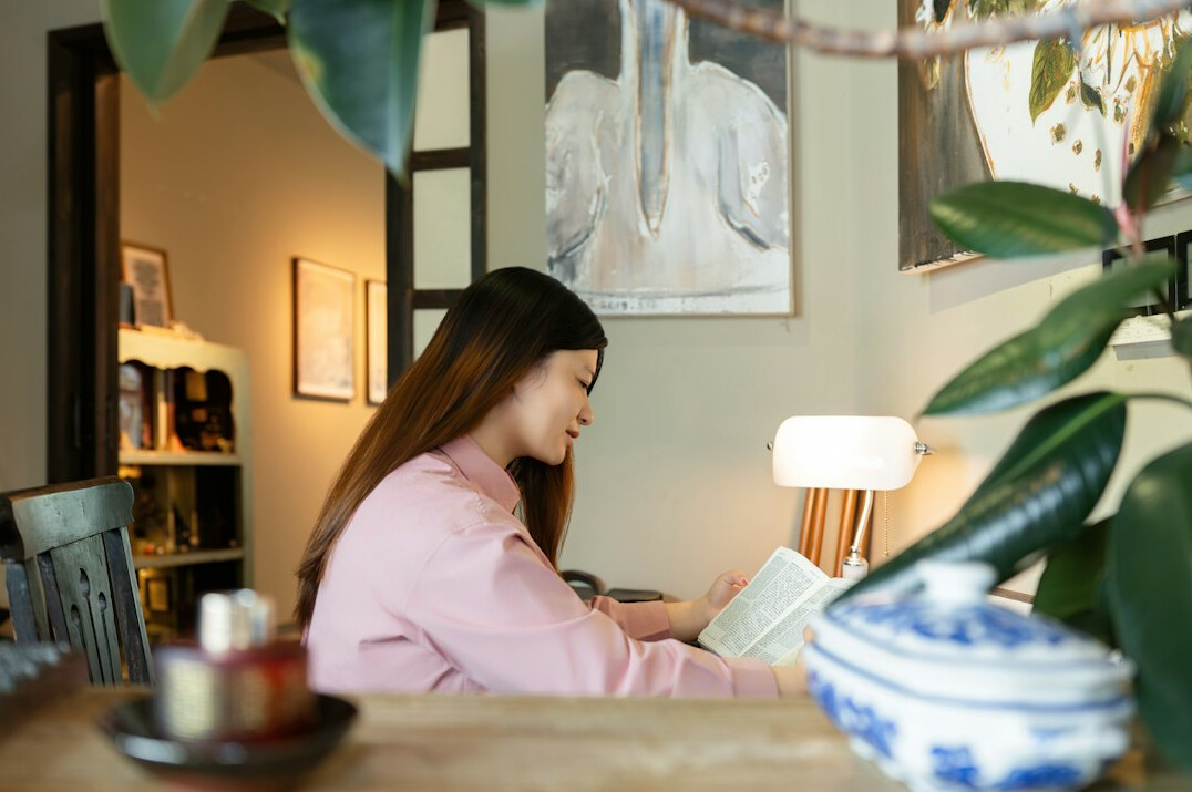 person reading finance book at home