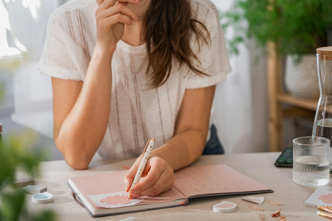 person writing budget list