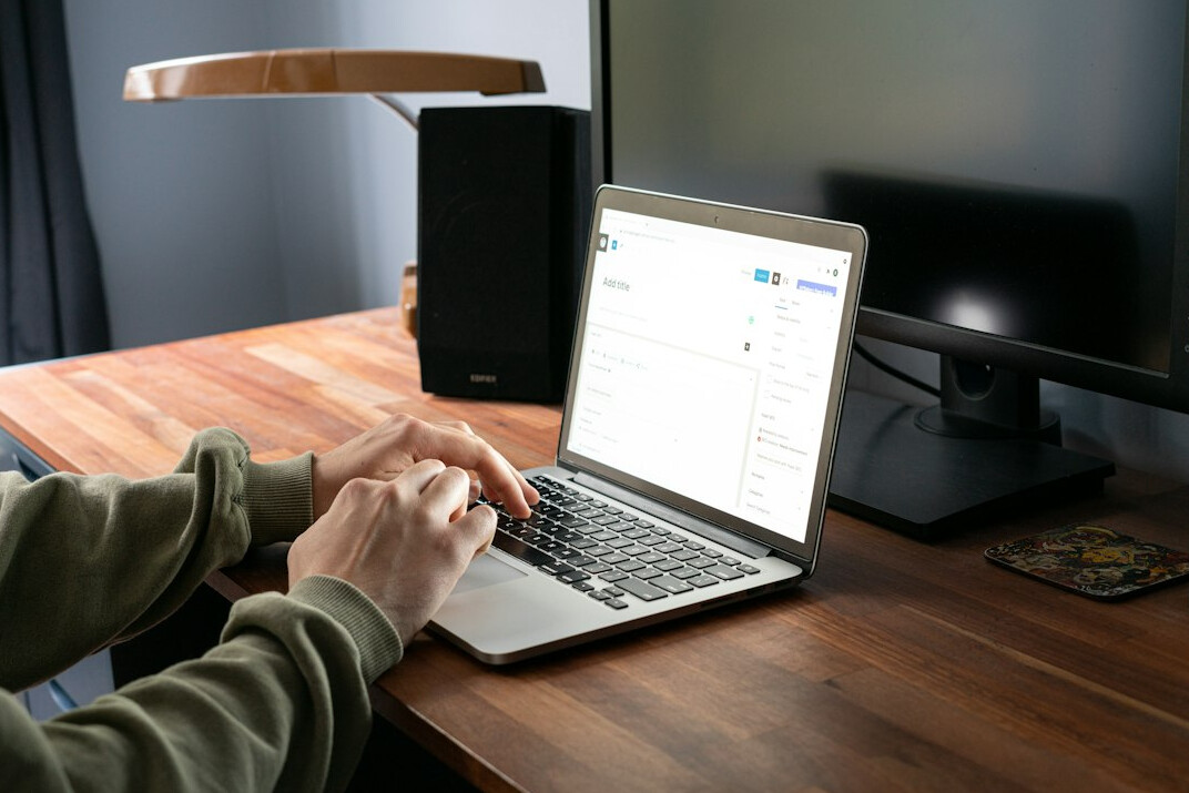 person tracking expenses on laptop