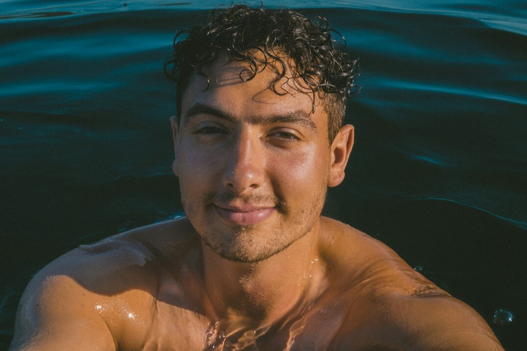 Portrait of a smiling Latin American man in his thirties with short dark hair